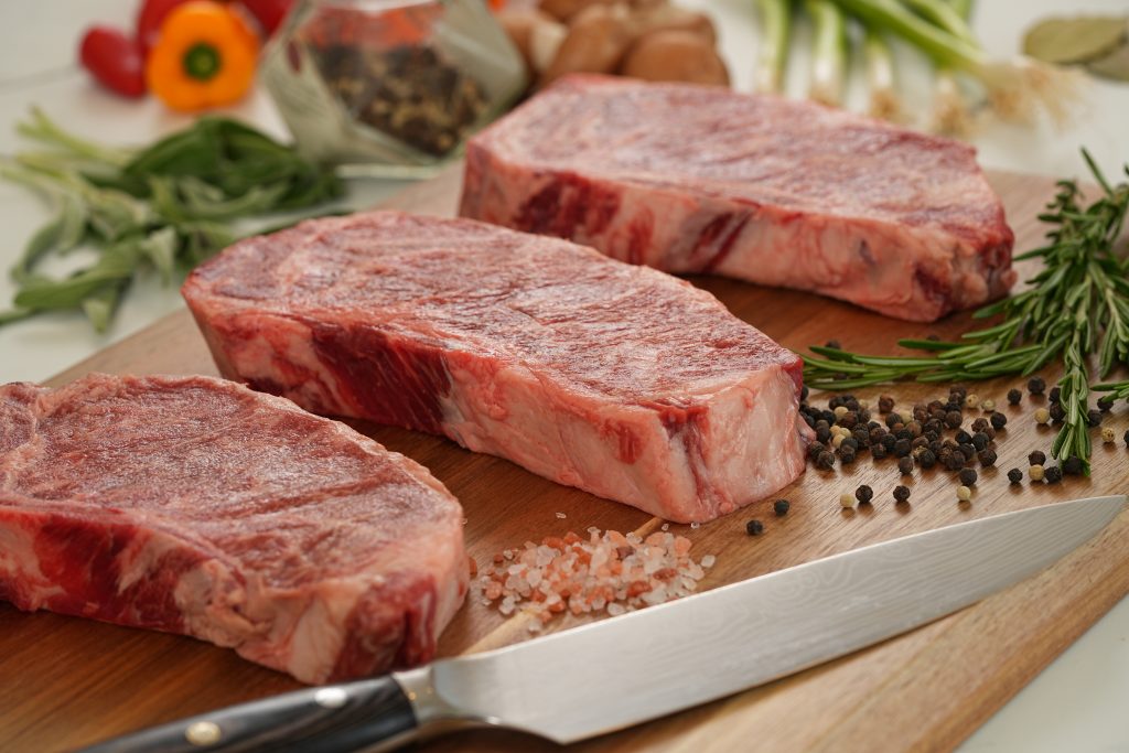 Uncooked 7X Beef steak showing rich marbling