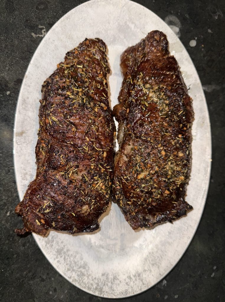 The end result - two perfect NY Strip Steaks